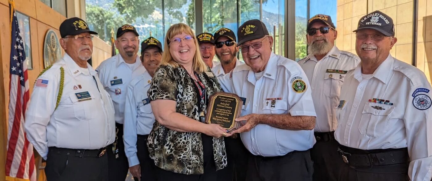 Honor Guard presenting a plaque to Cindy Van Bibber